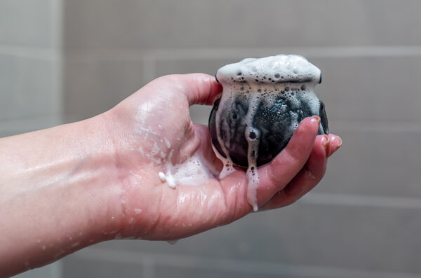 hand holding a cauldron-shaped bath bomb