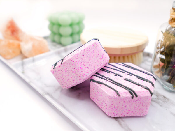 two pink hexagonal-shaped lavender vanilla bath bombs