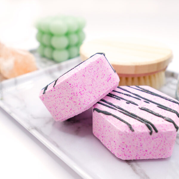 two pink hexagonal-shaped lavender vanilla bath bombs