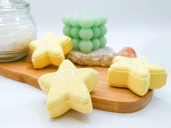 yellow star-shaped bath bombs on a wood wash board