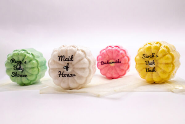 individually wrapped party favor bath bombs with decorative text on each favor