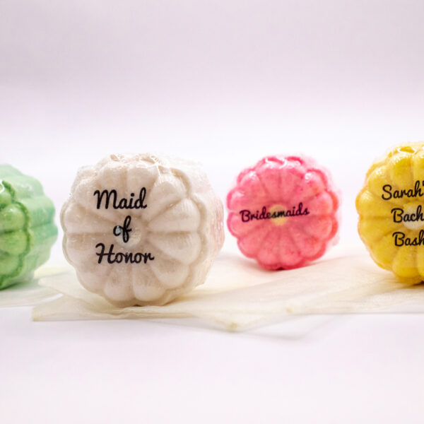 individually wrapped party favor bath bombs with decorative text on each favor