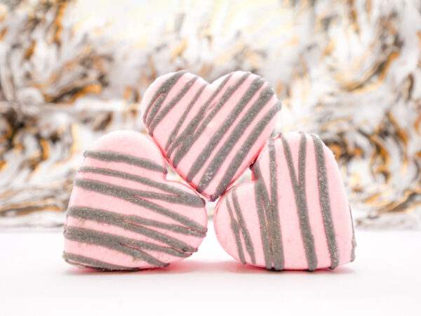 stack of pink heart-shaped prosecco and peony-scented bath bombs